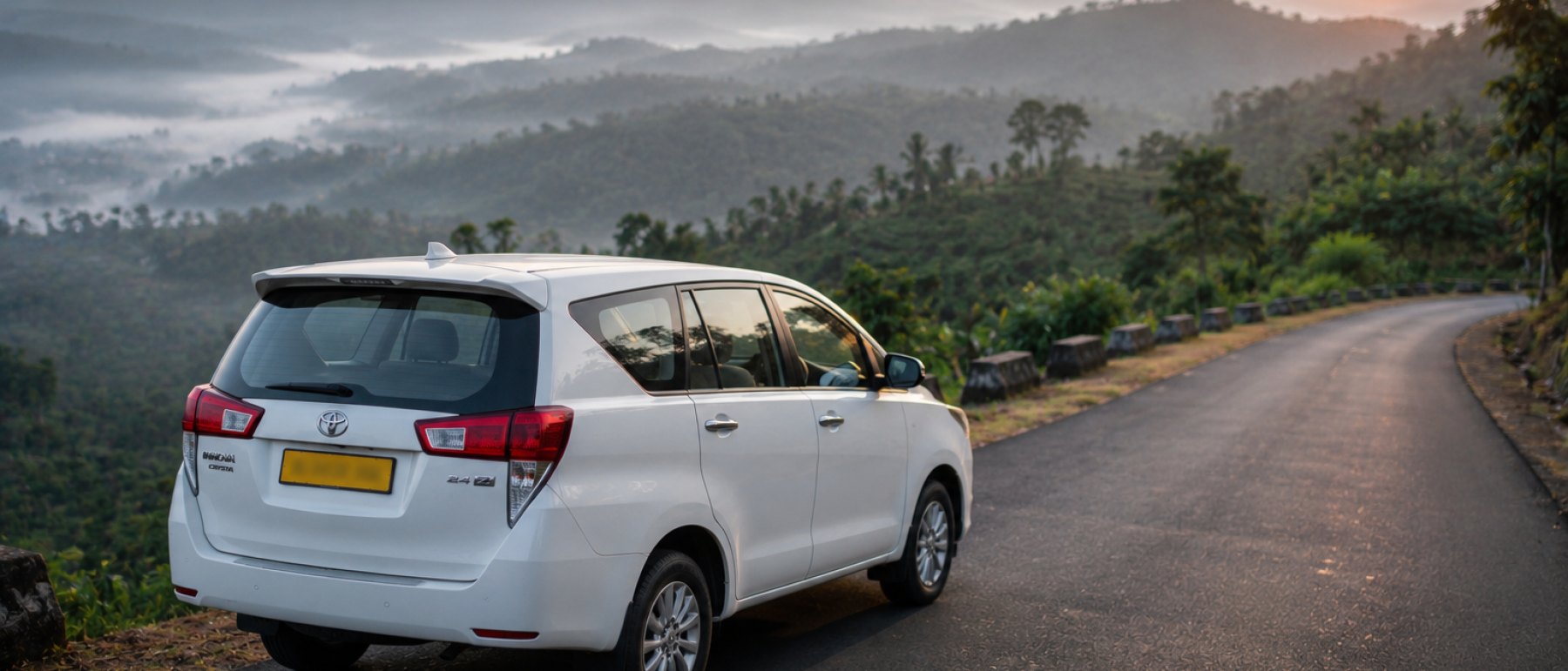 A Jain Cabs Innova on a hill road out of Bangalore at sunrise.